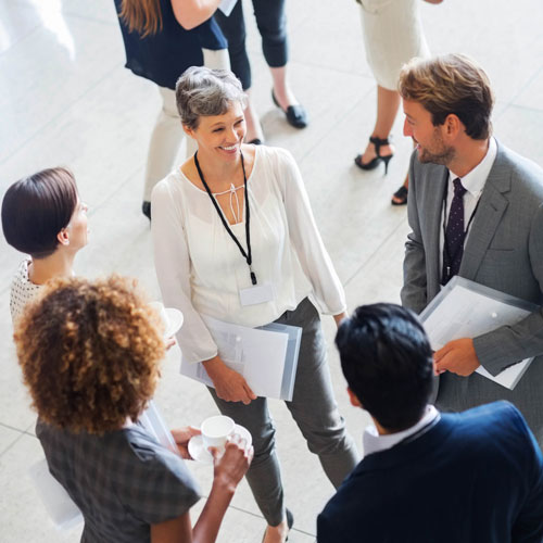 A group of people gathering in a business centre of a hotel